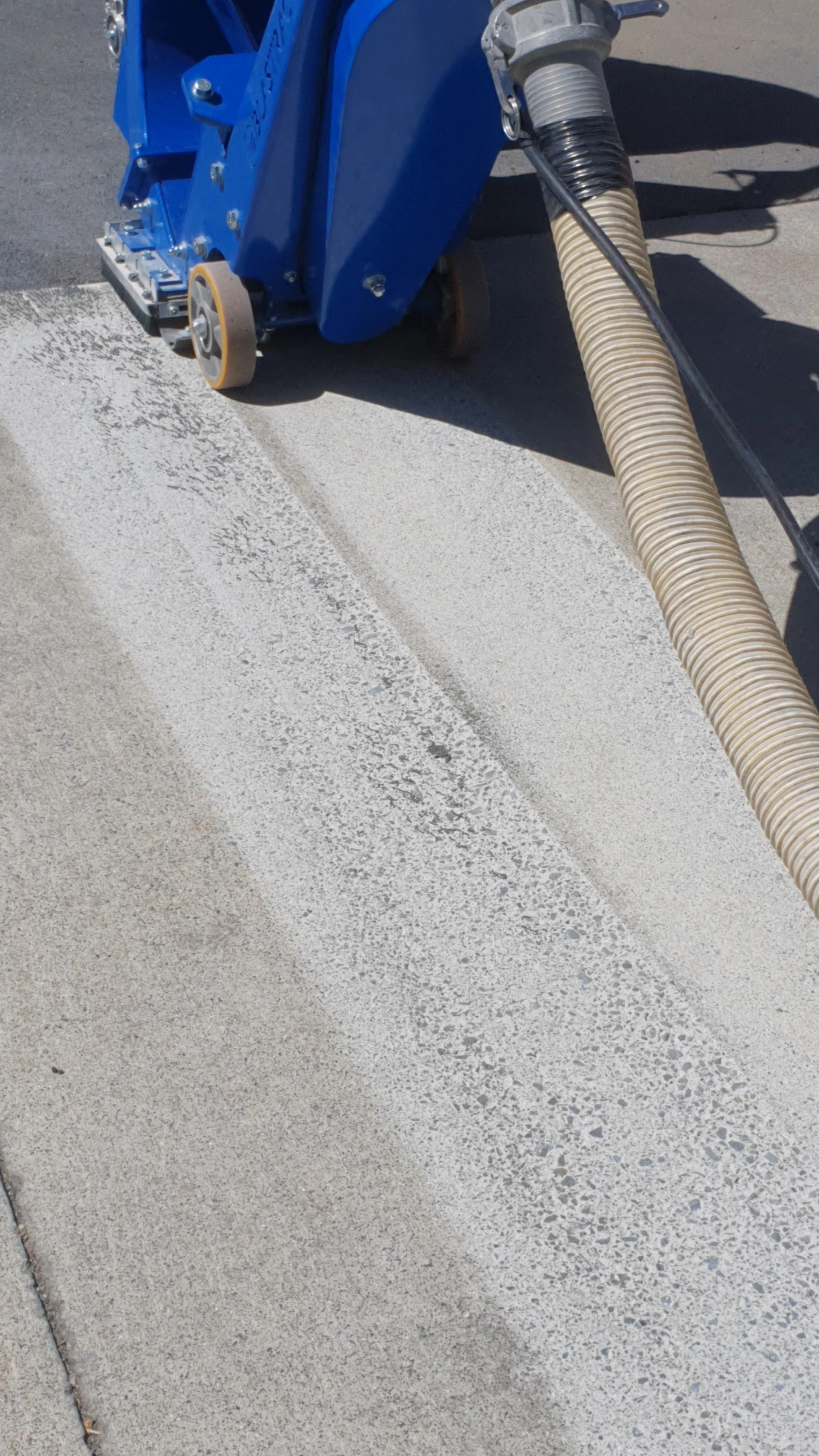 Concrete shotblasting machine cleaning a floor.